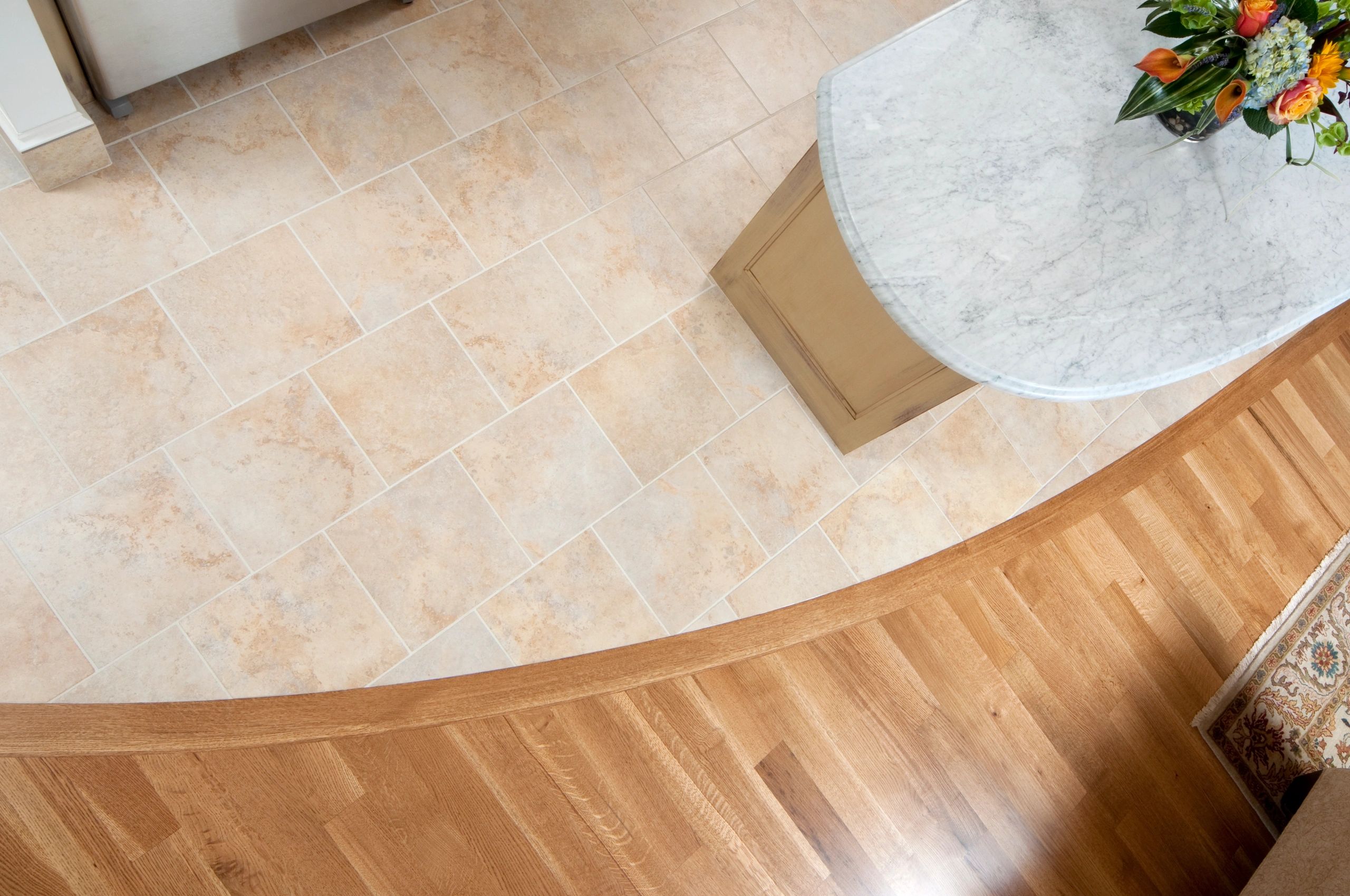Kitchen flooring detail showing clean tile-to-wood transition