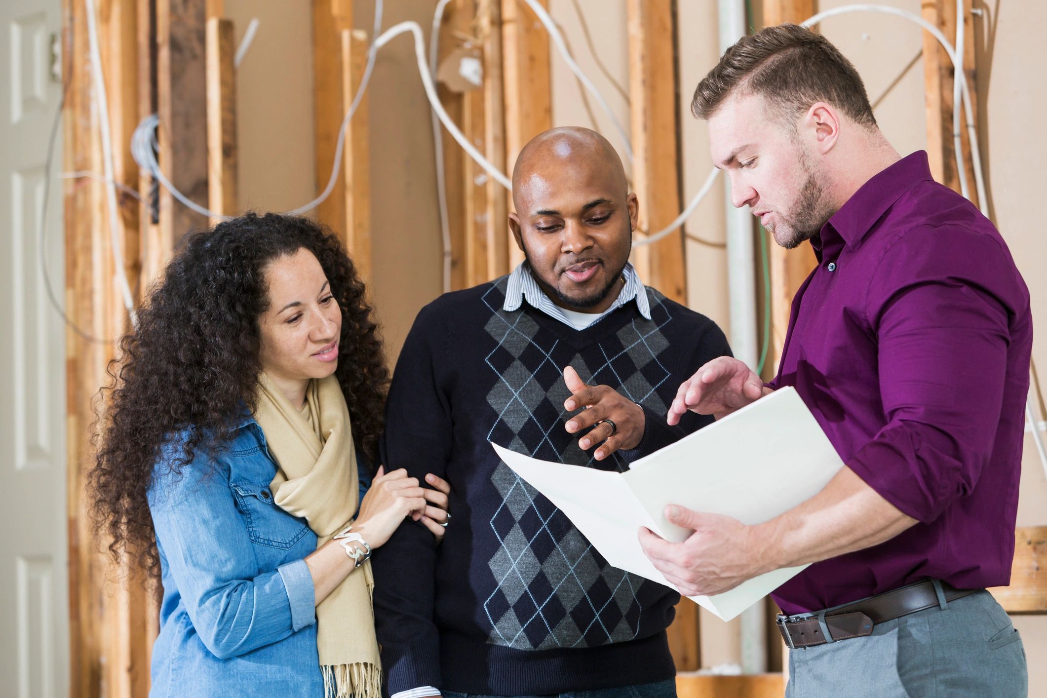 Homeowners reviewing paperwork with contractor
